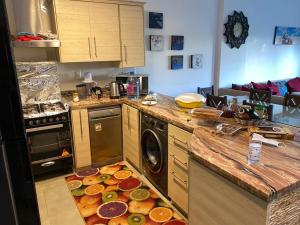 a kitchen with a bunch of food on the floor at Amwaj ground apartment in El Alamein