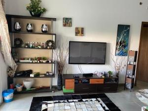 a living room with a flat screen tv on a wall at Amwaj ground apartment in El Alamein