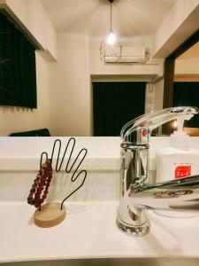 a bathroom sink with a chrome faucet at 無料駐車場付き恵美須町駅から190mあたたかくておしゃれな家 in Osaka +22 photos