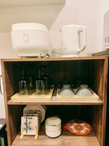 a cupboard with various kitchen items on top of it at 無料駐車場付き恵美須町駅から190mあたたかくておしゃれな家 in Osaka