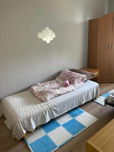 a bedroom with a bed with a pink blanket on it at Monika House in Warsaw