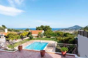 a balcony with a view of a swimming pool at Artemis Riviera Near Athen's Airport in Artemida
