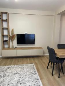 a living room with a flat screen tv on a wall at Lazmaris Suit in Çamlıhemşin