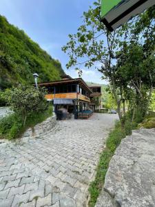 a building with a stone walkway in front of a building at Lazmaris Suit in Çamlıhemşin