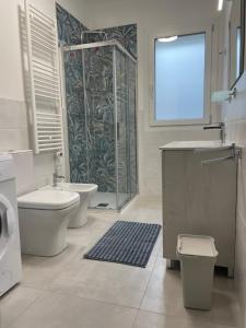 a bathroom with a toilet sink and a shower at Marina Garden in Cattolica
