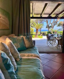 a couch in a room with a view of a patio at Bellavista Porto Rotondo in Porto Rotondo