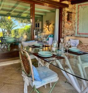 a dining room with a glass table and chairs at Bellavista Porto Rotondo in Porto Rotondo