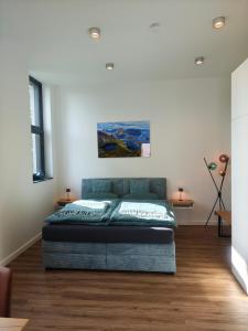 a bedroom with a bed in the middle of a room at Nordloft Bad Nenndorf in Bad Nenndorf
