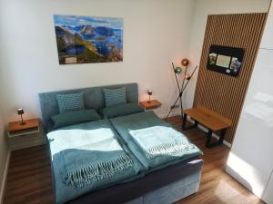 a bedroom with a bed with two pillows on it at Nordloft Bad Nenndorf in Bad Nenndorf