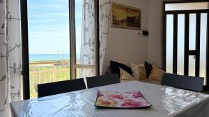 a dining room table with a view of the ocean at PP07 - Porto Potenza, trilocale vista mare con aria condizionata in Porto Potenza Picena