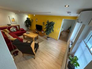 an overhead view of a living room with a red couch at FeWo "Luna Meadow" im RausHaus Heed in Meinerzhagen +5 photos