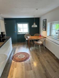 a dining room with a wooden table and chairs at FeWo "Luna Meadow" im RausHaus Heed in Meinerzhagen