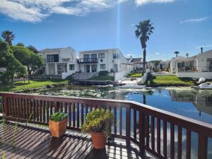 a view from the deck of a house with a pond at Spearhead on Lake Accommodation-5A in Marina da Gama