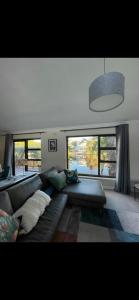 a living room with a couch and a large window at Spearhead on Lake Accommodation-5A in Marina da Gama