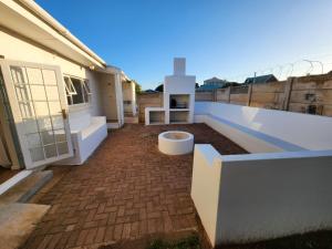 a balcony of a house with a toilet on it at At Let se Plek in Jeffreys Bay