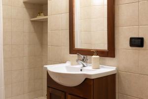 a bathroom with a white sink and a mirror at Casa Caminari in Grottaglie +11 photos