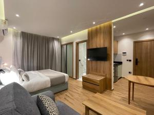 a hotel room with a bed and a television at Alfa Residence in Cairo