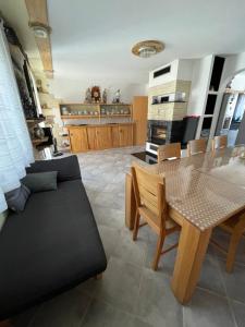a kitchen and dining room with a table and a couch at Gemütliches Haus im Herzen des Schwarzwaldes für bis zu 9 Personen in Elzach