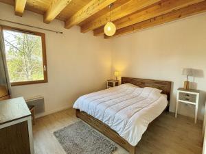 a bedroom with a bed and a window at Chalet 8 pièces avec spa, sauna, 15 pers, à 800m des pistes, Notre-Dame-de-Bellecombe - FR-1-595-1 in Notre-Dame-de-Bellecombe