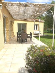 a patio with a table and chairs on it at Le Clos St Roch- Family home in Montpellier! in Montpellier