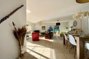 a kitchen and living room with a table and chairs at Le Clos St Roch- Family home in Montpellier! in Montpellier +26 photos