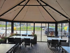 a large tent with tables and chairs in a restaurant at Pas Nerijų in Skuodas