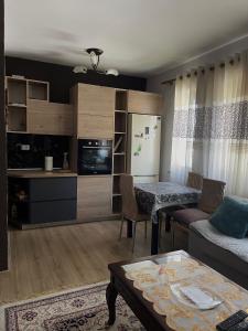 a living room with a couch and a table at Shkodra City Apartment in Shkodër