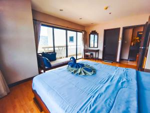 パトンビーチにあるPatong Towerの青い毛布が掛けられた大きなベッドのある寝室