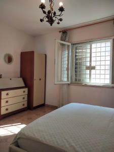 a bedroom with a bed and a dresser and a window at Etna view Villa Letizia a Taormina in Taormina