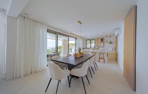 a kitchen and dining room with a table and chairs at Cozy Home In Prizba, Blato in Prizba