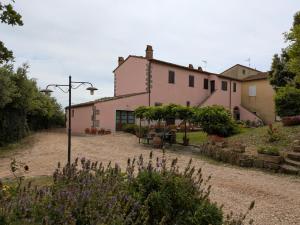 a pink house with a garden in front of it at Il Giovannello in Roccastrada