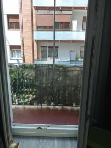 an open door to a balcony with a view of a building at Habitación in Bilbao