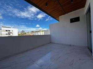 a balcony with a white wall and a blue sky at Bauten Home Stay Próximo ao Shopping, Centro e Pátio do Forró in Caruaru