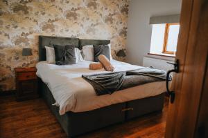 a bedroom with a bed with pillows on it at Vale Farm Cottages in Brecon +183 photos