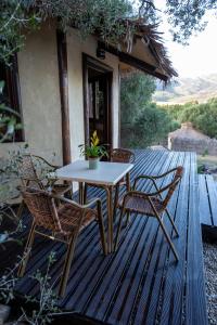 a table and chairs on a wooden deck at Cabaña Tanzania in Tarifa