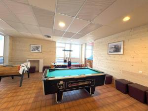 a billiard room with a pool table and a pool table at Hôtel Club Le 1850 Risoul in Risoul