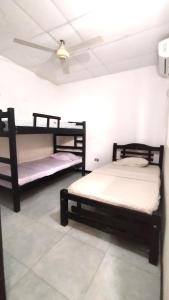 two bunk beds in a room with a ceiling at GiGi House 2 in Taganga