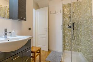 a bathroom with a sink and a shower at River House Lenno - Tremezzina - Como Lake in Lenno