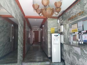 a hallway in a building with a chandelier at LibeStay in Busan
