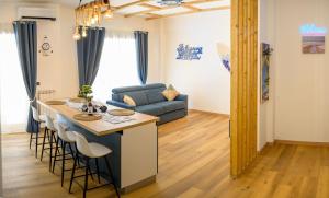 a kitchen and living room with a couch and a table at Nido Azzurro Luxury House in Lido di Ostia