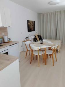 a kitchen and dining room with a table and chairs at Черно море, Кранево, студио 2 in Kranevo