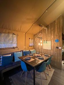 a dining room with a table and blue chairs at Metaxaki 1 in Mikros Gialos +13 photos