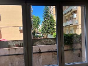 a window with a view of a building at RomeCookSea Guest House in Lido di Ostia