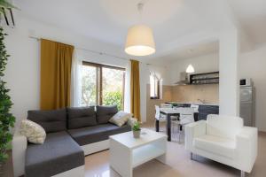 a living room with a couch and a table at Istria Sea Side Apartments Lina in Labin