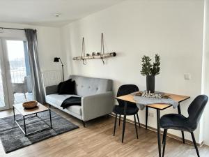 a living room with a couch and a table at Charming Homes - Studio 10 in Wolfsburg