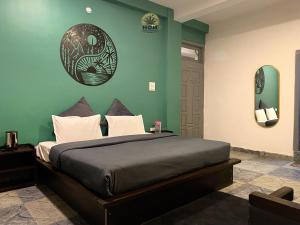 卡索尔HOM House of MannMauji Riverside kasol的一间卧室，配有一张床和绿色墙壁