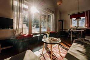 a living room with a table and a large window at Bukolik in Bukowiec