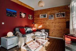a living room with a couch and a wooden wall at Bukolik in Bukowiec