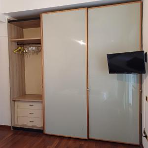 a closet with a sliding door with a tv on it at A casa di Lilly in Rome