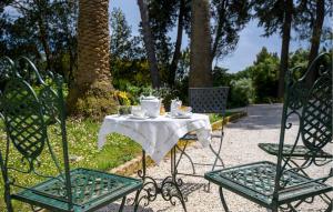 a table and chairs with a tea set on it at Gorgeous Home In Porto San Giorgio in Porto San Giorgio
